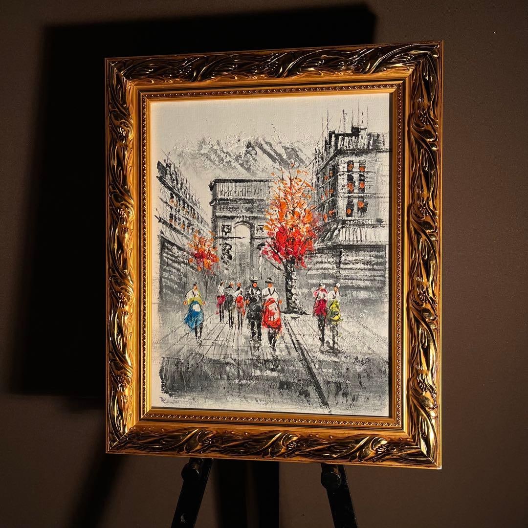 The oil painting featuring a motif of a skull and triangle, with a gold frame.: (Source text: An oil painting featuring a skull and triangle motif, with a gold frame.) Hand-painted oil painting depicting a Parisian landscape, including the Arc de Triomphe, framed and entirely han