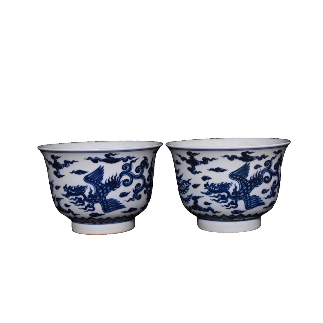Ming Xuande Blue and White Phoenix Pattern Cups: A pair of Ming Dynasty Xuande period blue and white phoenix motif stem bowls, measuring 10.8×15.3 centimeters. This pair of stem bowls perfectly showcases the brilliance of Ming Dynasty porcelain art