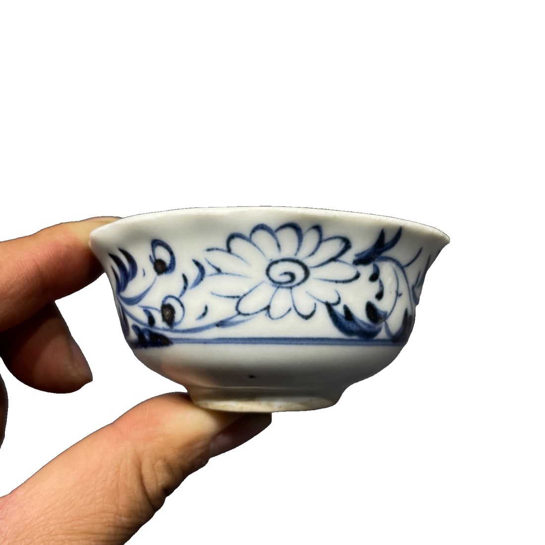 Ming Dynasty Blue and White Floral Tea Bowl: This Ming Dynasty blue and white floral-patterned tea bowl showcases the exquisite craftsmanship of Ming Dynasty blue and white porcelain through its intricate floral designs and unique glaze color. T