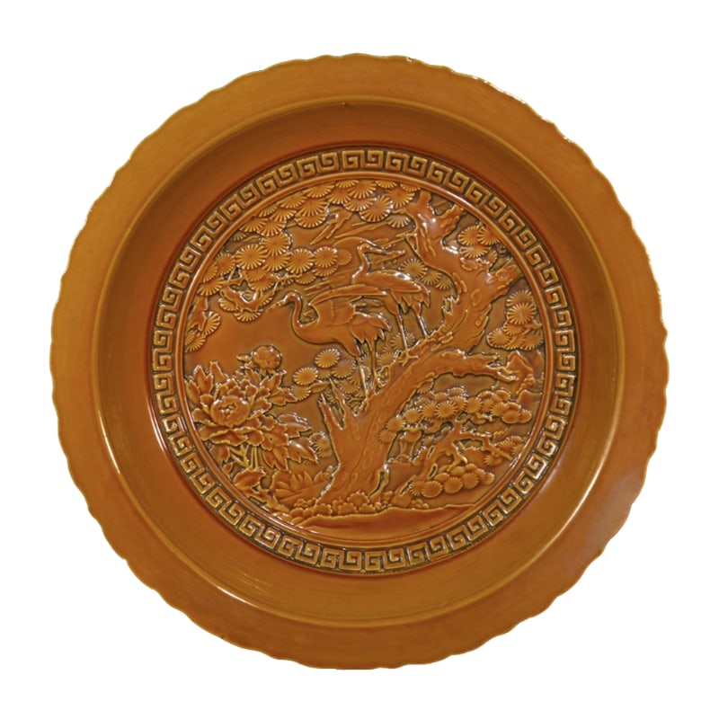 Qianlong Yellow Glaze Plate with Pine and Crane Design: Qing Dynasty, Qianlong Period Yellow Glazed Relief Plate with Pine and Crane Longevity Design, measuring 6.8 cm in height and 43 cm in diameter, is an exquisite art piece embodying the essence of