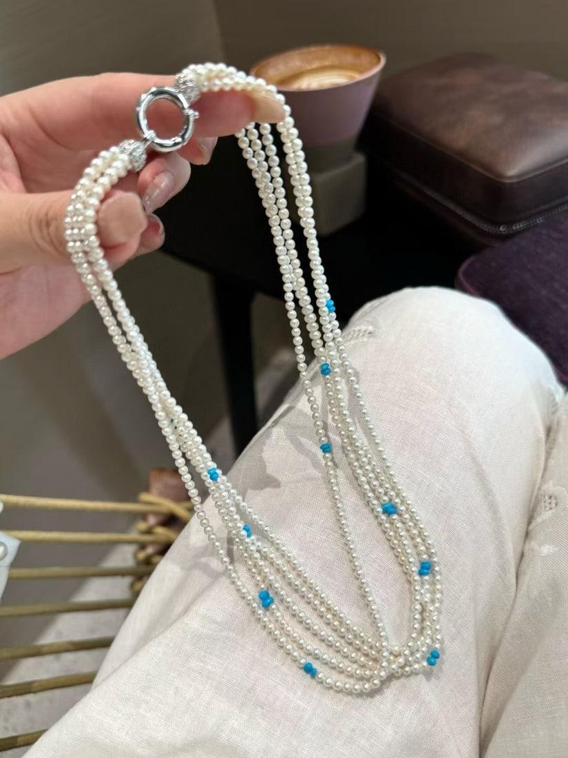 Natural Pearl Necklace: This necklace embodies the elegance of a classical beauty with its multi-layered design featuring five layers of baby pearls, each with a diameter of 5-4mm. The pearls exhibit a natural rich gold and 