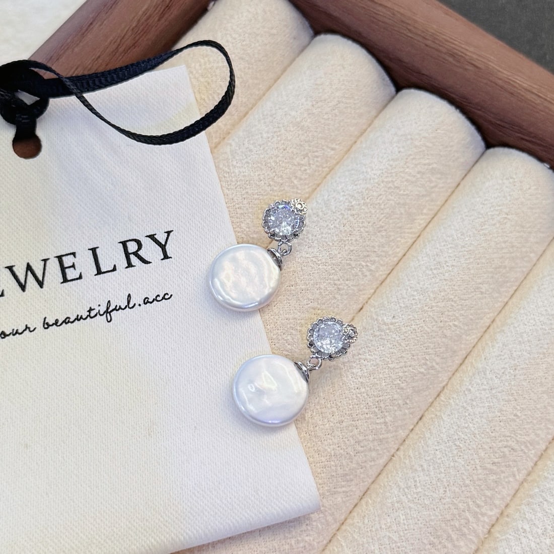 Natural Button Pearl Earrings: These earrings feature natural button pearls, showcasing a luxurious golden hue with a cool white luster and large diameter. The pearls are nearly flawless with a perfect round shape, complemented by 