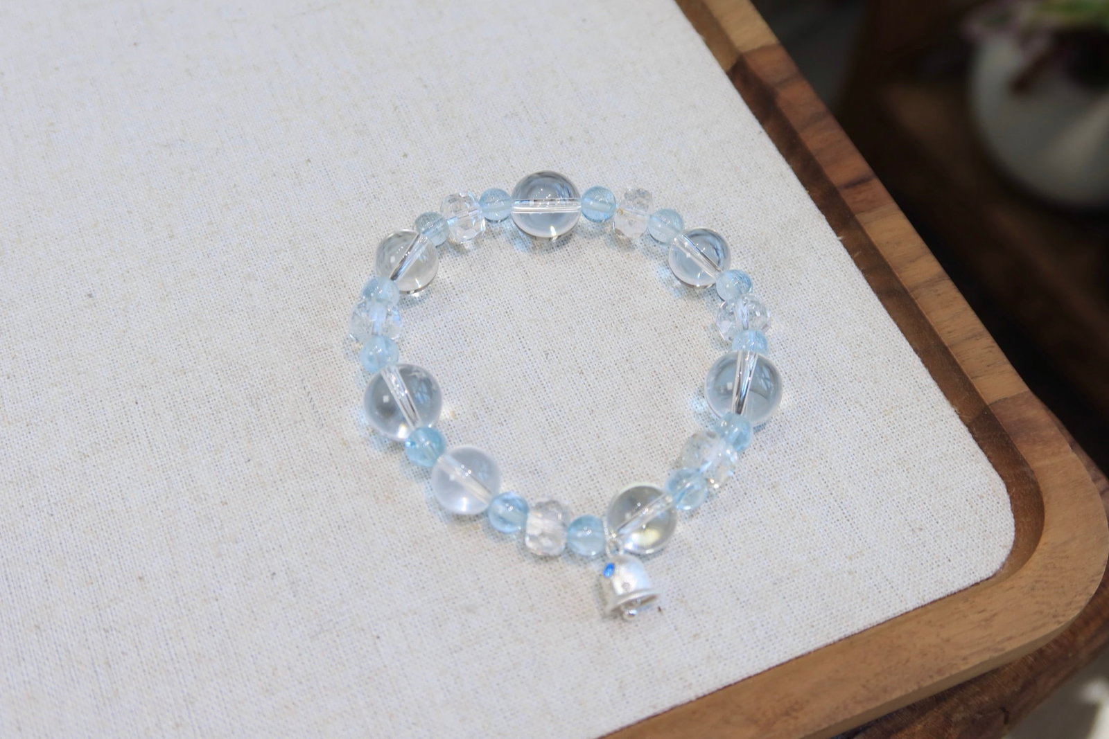 Brushed Silver Topaz Bracelet: This bracelet features natural topaz, showcasing a cool white hue with an icy translucent texture. Paired with 12.5-10mm white crystal bubble beads, the faceted white crystal complements the brushed s