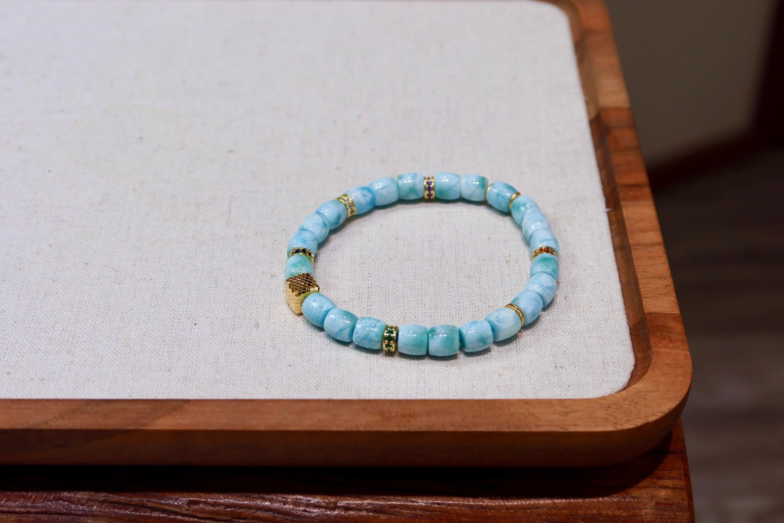 Natural Larimar Bracelet: This natural Larimar bracelet showcases a unique cool white hue. With large diameter beads and minimal blemishes, it captivates at first sight. The exquisite craftsmanship of gold with diamond-studded