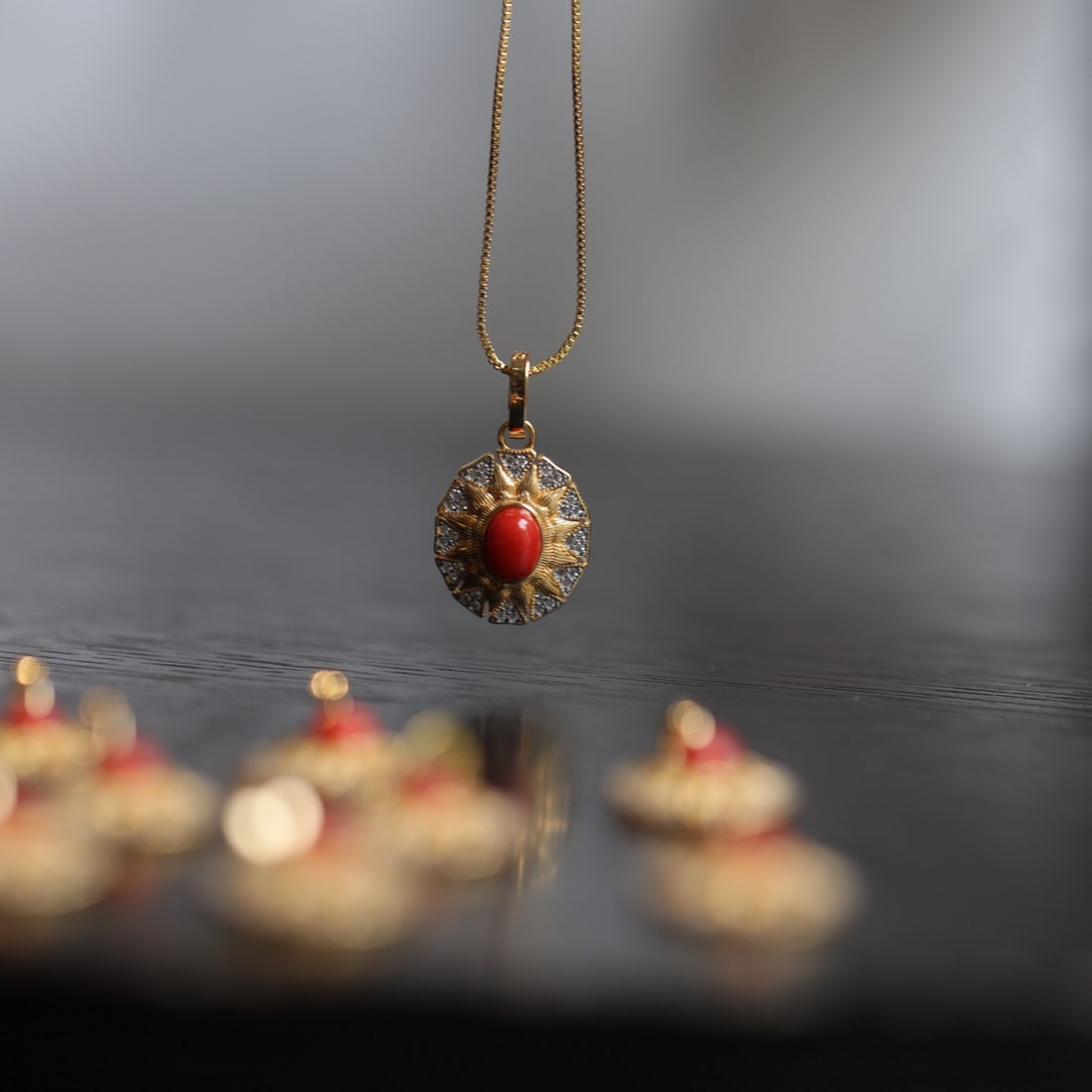 S925 Silver Natural Red Coral Pendant: This pendant features a vibrant natural red coral as the main stone, set in S925 silver with a gilded and diamond-accented sunburst design. Its exquisite and luxurious style complements both formal