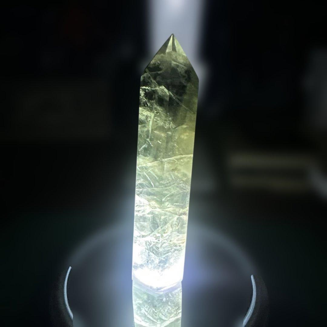 Hexagonal Natural Fluorite Ornament, Transparent Raw Stone: Unique Hexagonal Natural Fluorite Ornament, Transparent Raw Stone, Approximately 10 cm, with Some Sparkle. This is a natural fluorite, meticulously polished into a hexagonal prism shape. The soft, tra
