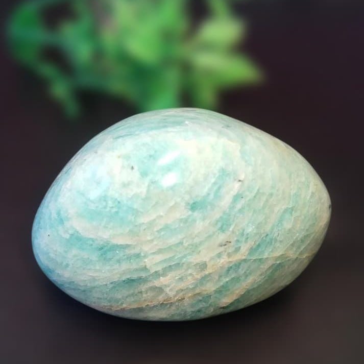 Polished Amazonite Stone: Amazonite Polished Stone Dimensions: 43 x 28 x 35 mm Weight: 51.7 grams This Amazonite polished stone features a beautiful mint green base color with white stripes. Its rounded shape adds to its charm