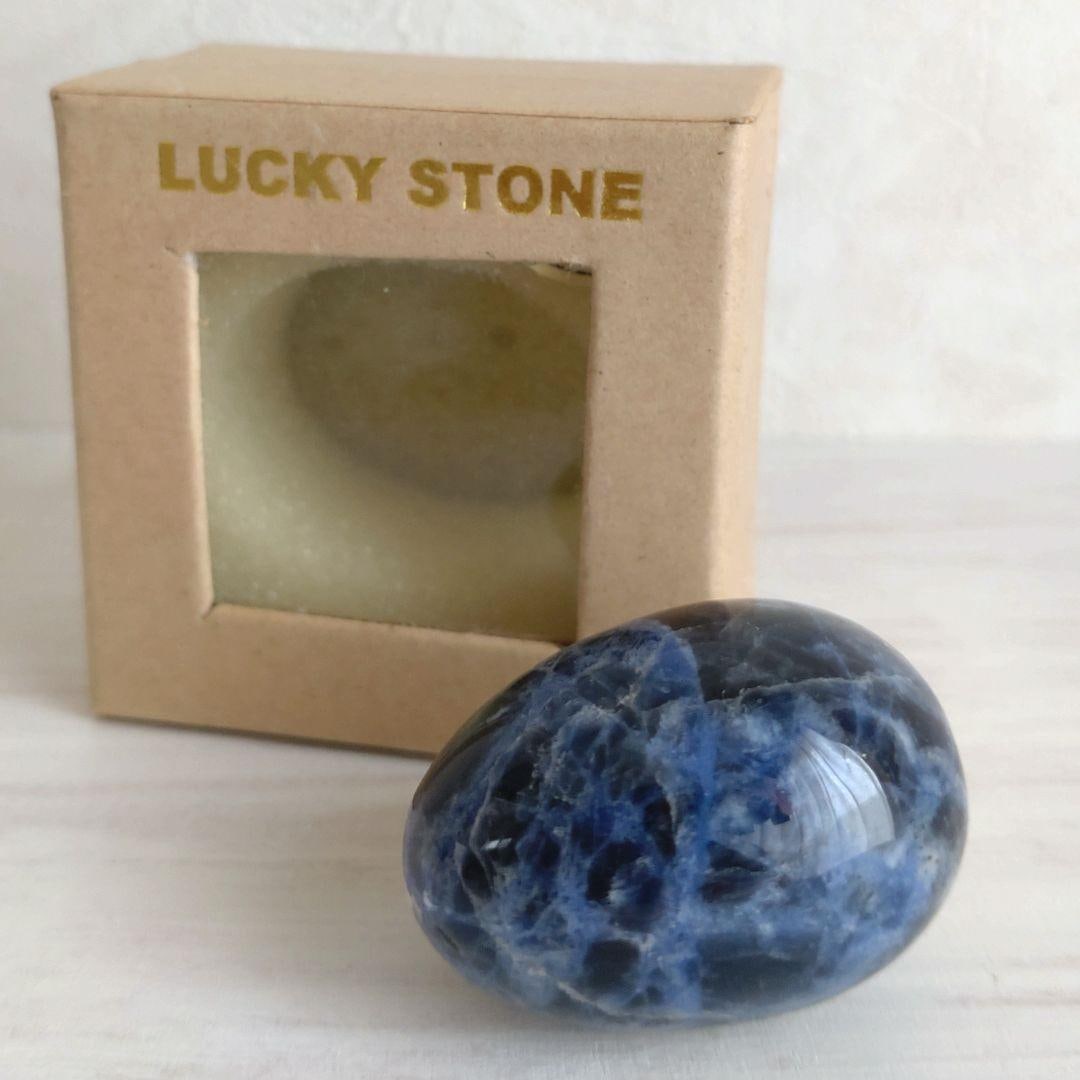Natural Sodalite Oval Polished Stone: Natural Sodalite Egg-Shaped Polished Stone These are naturally occurring sodalite stones that have been polished. Unlike flat stones, these feature a beautiful three-dimensional egg shape. Their