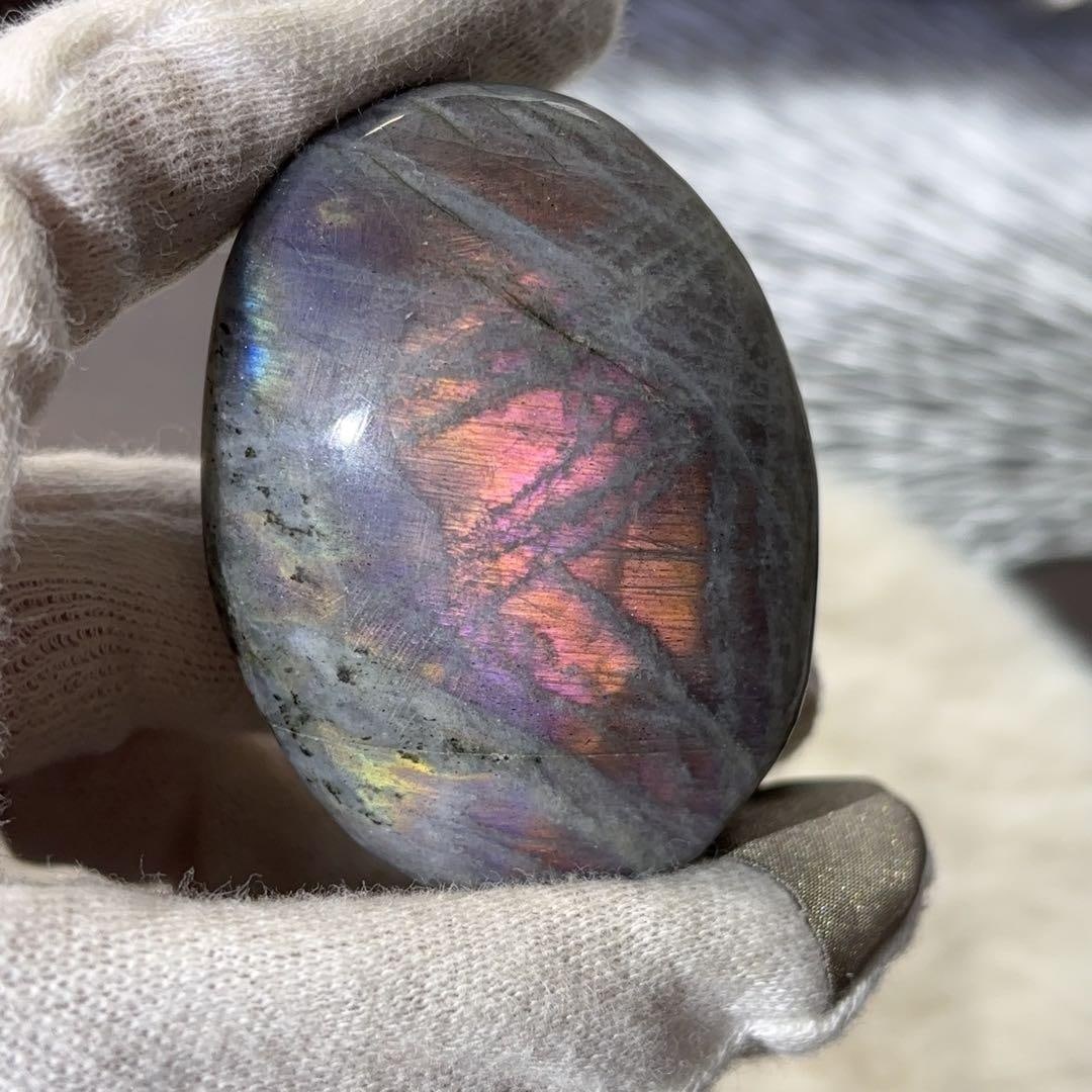 Hand-Carved Natural Labradorite Gemstone: Natural Hand-Carved Labradorite Gemstone, Blue, Purple, Pink, Red This is a handheld piece of labradorite. The Schiller effect is visible on both the front and back. The colors include purple, blue,
