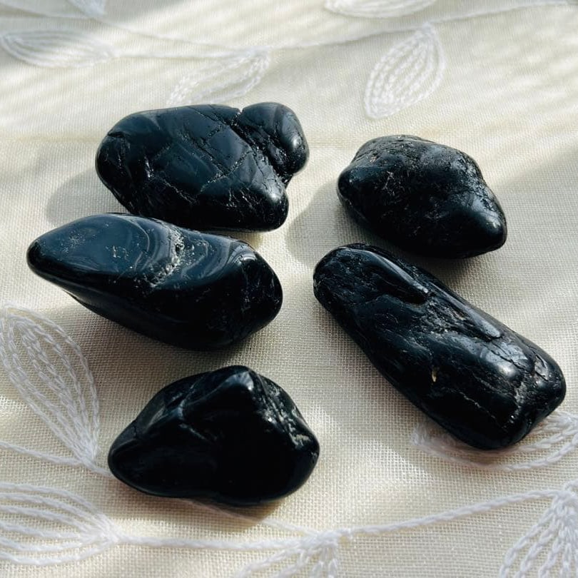 Brand new, unused large black tourmaline polished stones (set of 5).: Brand New Unused Large Black Tourmaline Polished Stones (Set of 5) Large Black Tourmaline Polished Stones - Set of 5 This is a larger piece of raw black tourmaline. Black tourmaline is known for its