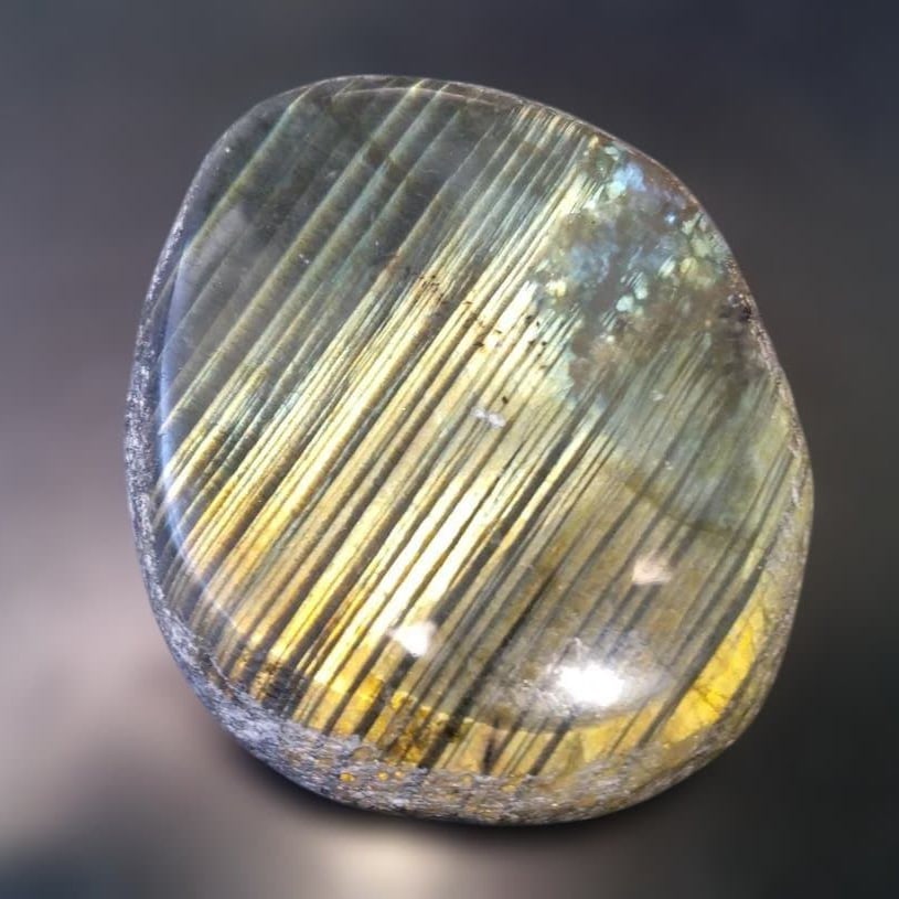Polished Golden Labradorite: Polished Golden Labradorite Golden Labradorite Dimensions: 48 x 56 x 16 mm Weight: 89 grams When light strikes its surface, the entire piece radiates a magnificent golden glow. This is an