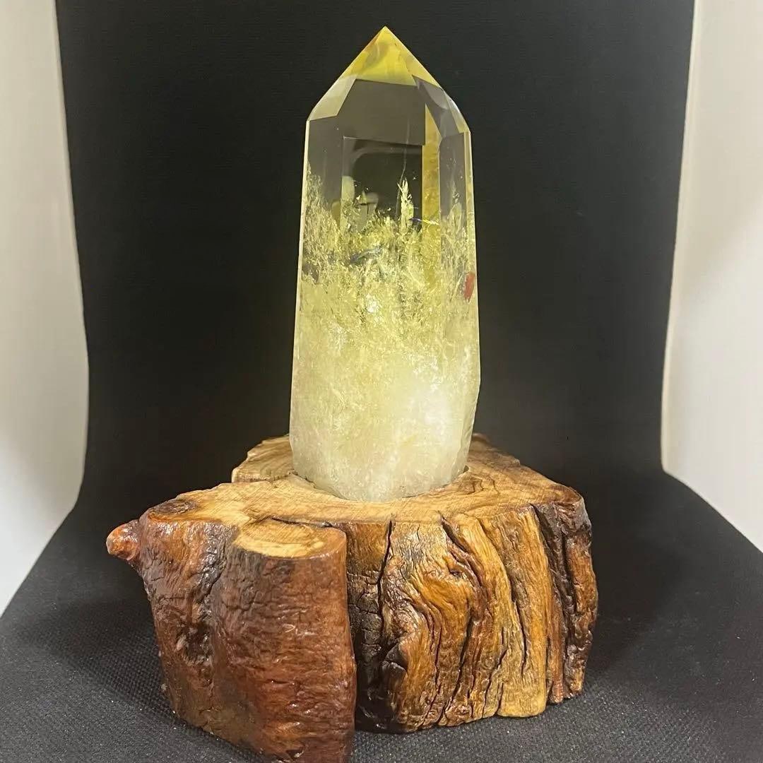 Yellow crystal column, hexagonal prism shape.: High-Quality Natural Citrine Crystal Pillar, Hexagonal Prism, with Wooden Base, 407 grams This is a high-quality citrine (yellow quartz) natural crystal sourced from Brazil. It comes with a wooden