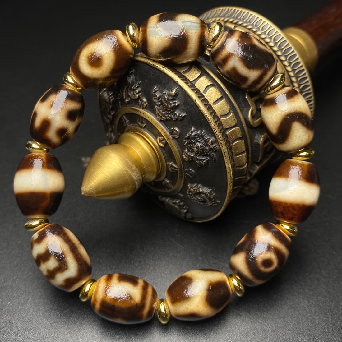 Dzi Bead Bracelet: Old Material High-Oil Patina Dzi Bead Bracelet, measuring 16x11 mm, consisting of 11 beads. The Dzi bead totems are clear, with a delicate orange peel texture and a rich patina. Pure Dzi beads are ext