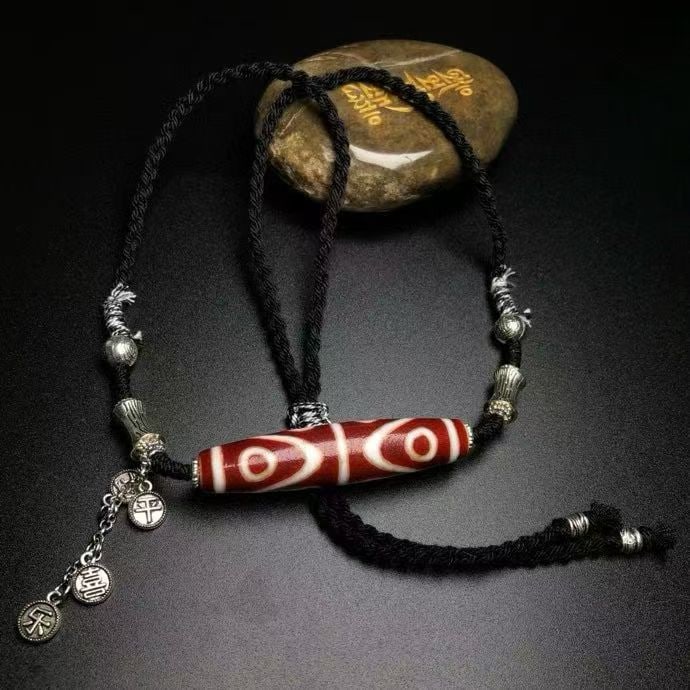 Eight-Eyed Dzi Bead Necklace: Old Material High-Oil Patina Red Meat Eight-Eyed Dzi Bead Necklace with Tibetan Silver for Peace and Joy. Dimensions: Eight-Eyed Dzi Bead 58x13 mm. The totem is clear and smooth, with visible horse ho