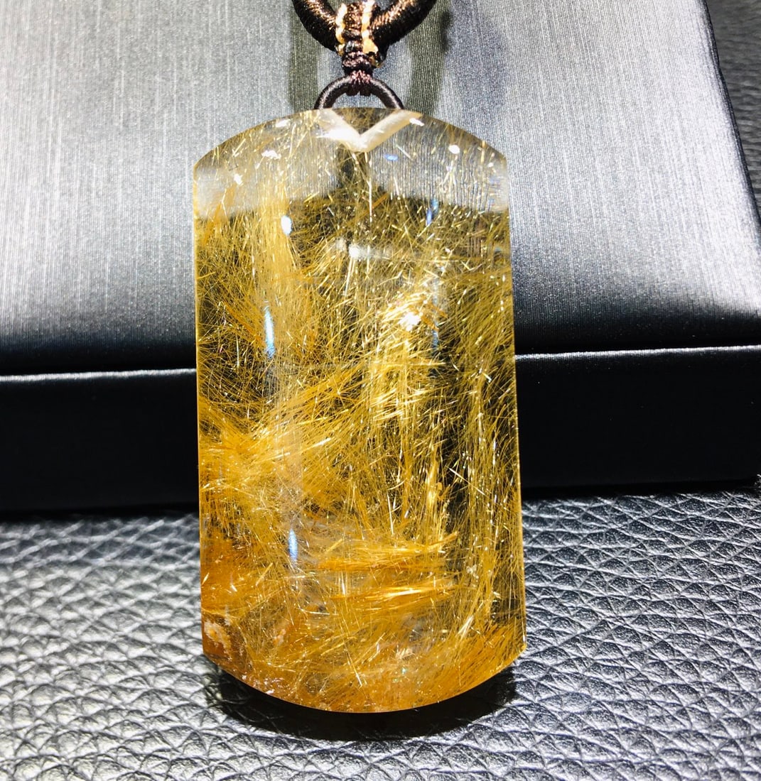Natural Golden Rutilated Quartz Pendant: This natural golden rutilated quartz pendant symbolizes peace and prosperity, with a simple yet meaningful design. It is perfect for those seeking inner tranquility. (Size 44*23.5*9.3mm, weight