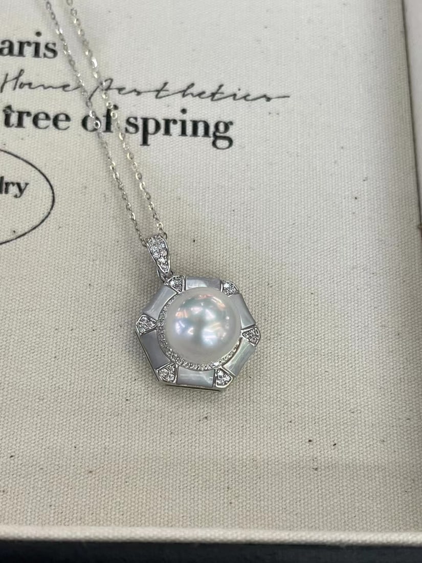 Sterling Silver Freshwater Edison Pearl Necklace: This accessory is crafted with precision, featuring 11-12mm freshwater Edison pearls. The pearls are perfectly round with a strong cold white mirror luster and are nearly flawless. (Size approximately