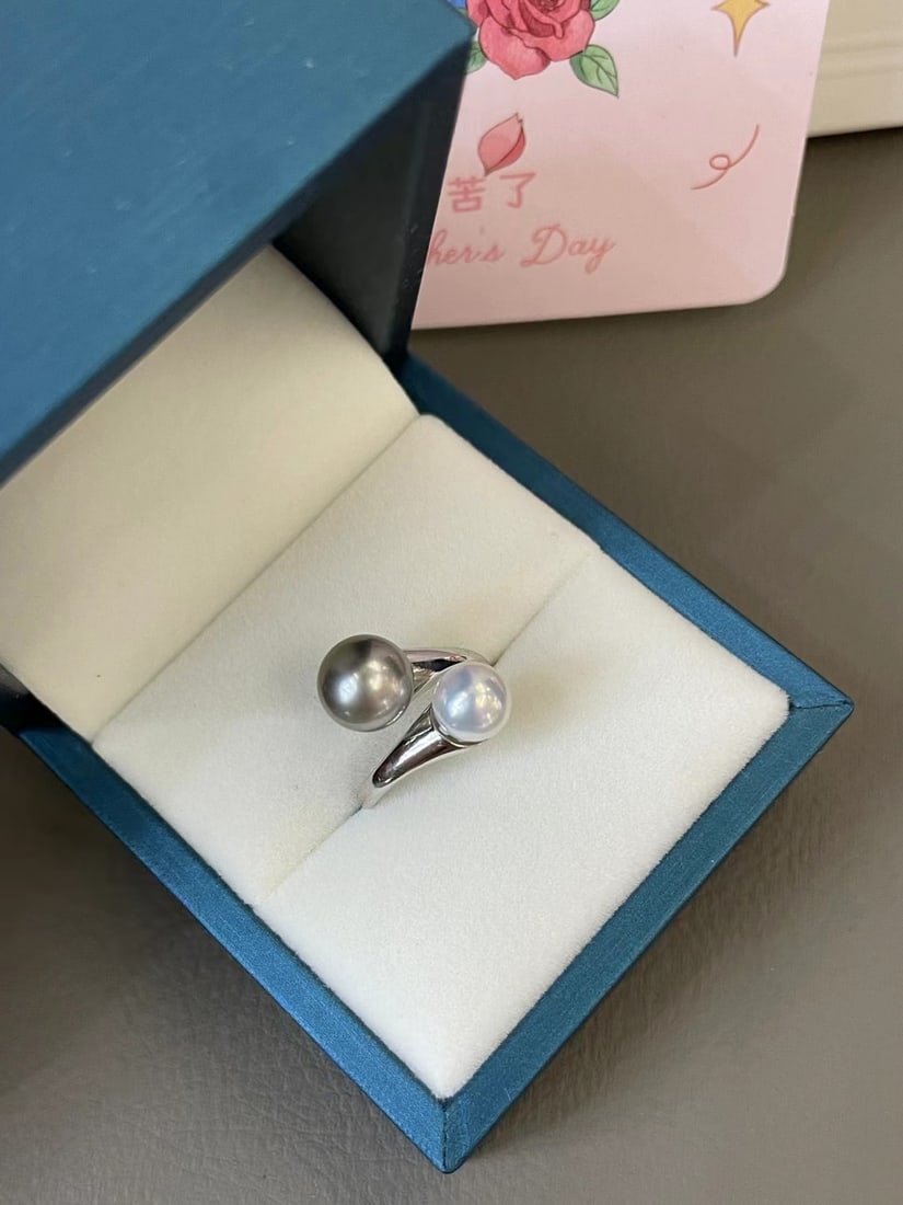 Sterling Silver Tahitian Pearl Ring: This classic and simple double pearl ring is crafted from finely thickened sterling silver, showcasing the natural luster of Tahitian pearls. The adjustable band design ensures comfortable and flexibl