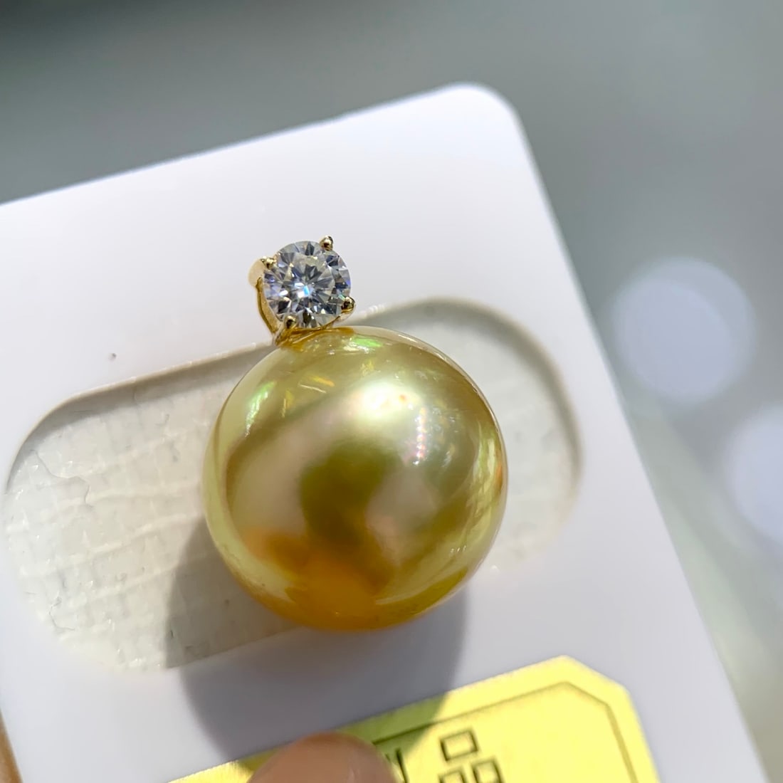 18K gold South Sea bead pendant: This pendant is crafted from 18K gold, featuring a slightly blemished South Sea golden pearl with a rich golden hue. Its generous design accommodates various chains, and the substantial gold texture i