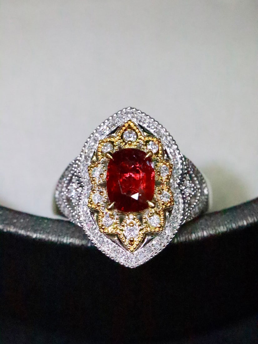Platinum Natural Unheated Ruby Ring: The vivid blood-red ruby sits at the center, exuding endless charm. Surrounding diamonds shine like warm sunlight, intertwining with the ruby to outline exquisite patterns, reminiscent of classical st