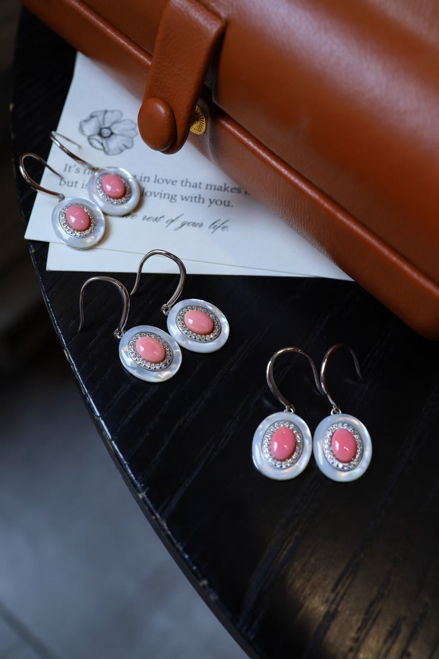 Sterling Silver Natural Cameo Shell Earrings: The pale pink hue of the cameo shell exudes natural elegance, enhanced by the soft glow of the white mother-of-pearl edging. The design is petite and lightweight, refined yet distinctive, perfect for