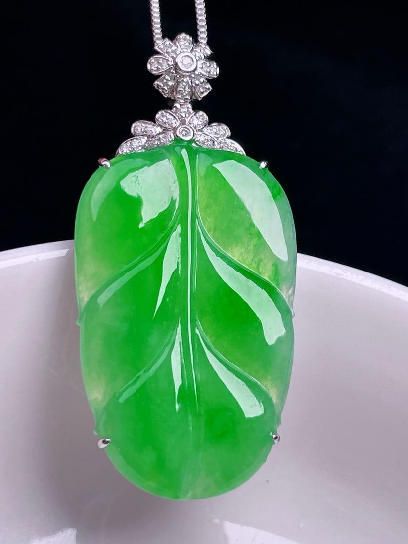 18K Gold Icy Yang Green Jadeite Pendant: This jadeite pendant is exquisitely set in 18K gold, showcasing the vibrant icy yang green hue. The jadeite is of old and watery texture, with a delicate quality that captivates. The overall design