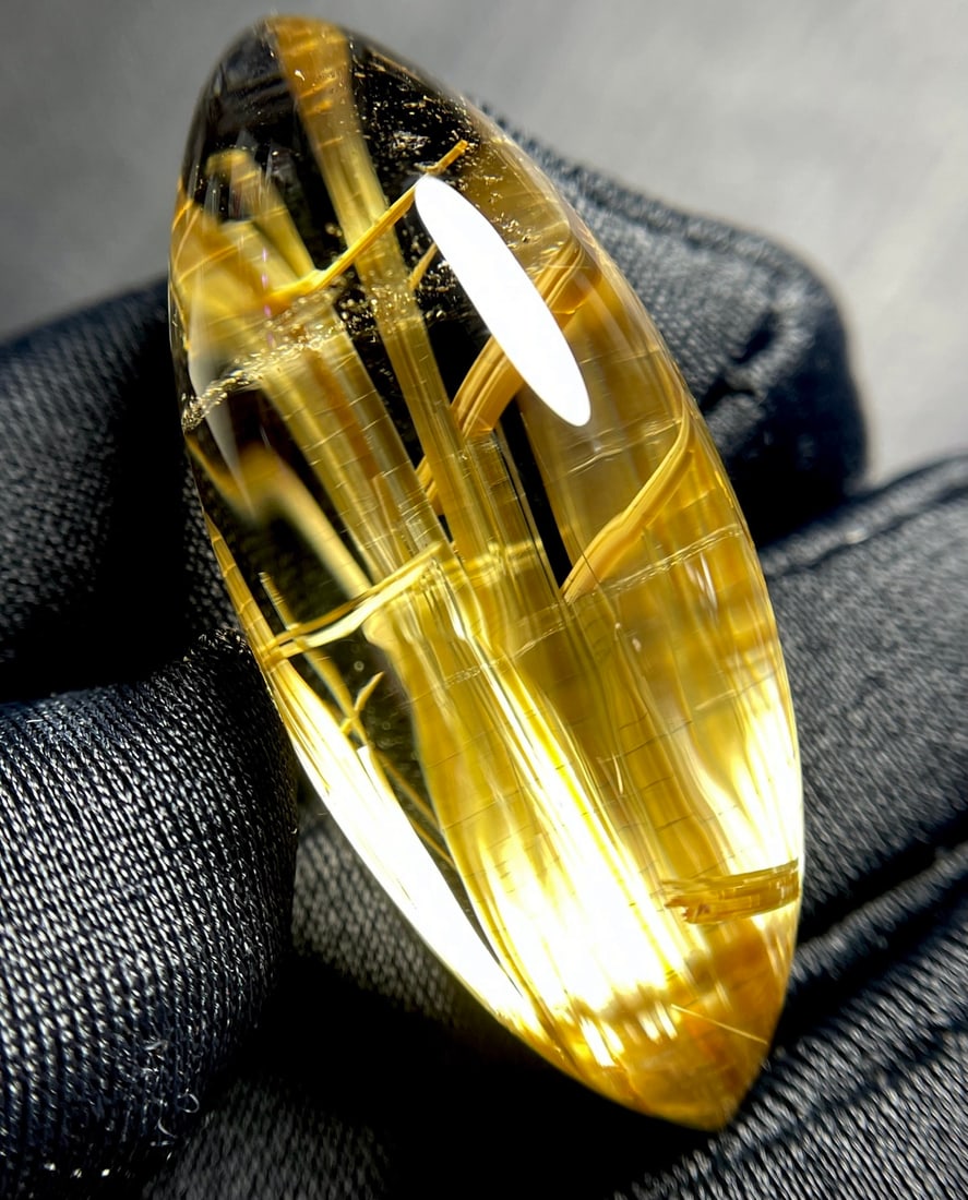 Natural Titanium Crystal Pendant: This pendant showcases the unique charm of rutilated quartz, with golden threads shining brilliantly in the light. Its marquise shape adds an elegant touch. (Dimensions: 35.3*14.8*10.6mm, Weight: 8.2g