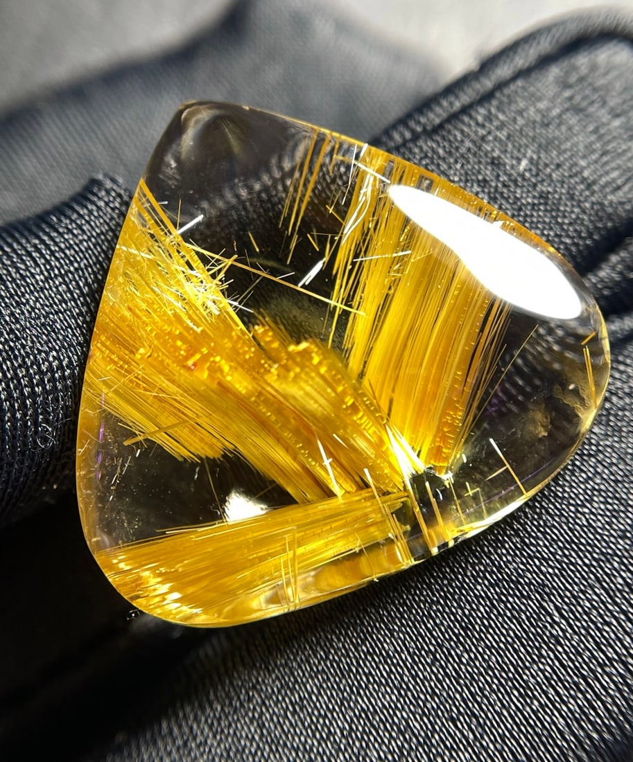 Natural Titanium Crystal Teardrop Pendant: This pendant showcases the unique charm of rutilated quartz, with a transparent crystal and dense, smooth rutile needles that shimmer with golden light. Its teardrop shape adds an elegant touch. (Dime