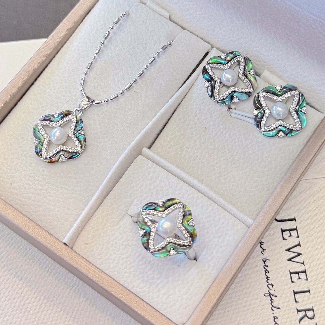 Natural Abalone and Freshwater Pearl Set: This set features natural abalone and freshwater pearls, showcasing an elegant design. Each pearl is carefully selected and set in a beautifully crafted base, exuding a captivating luster. Freight: