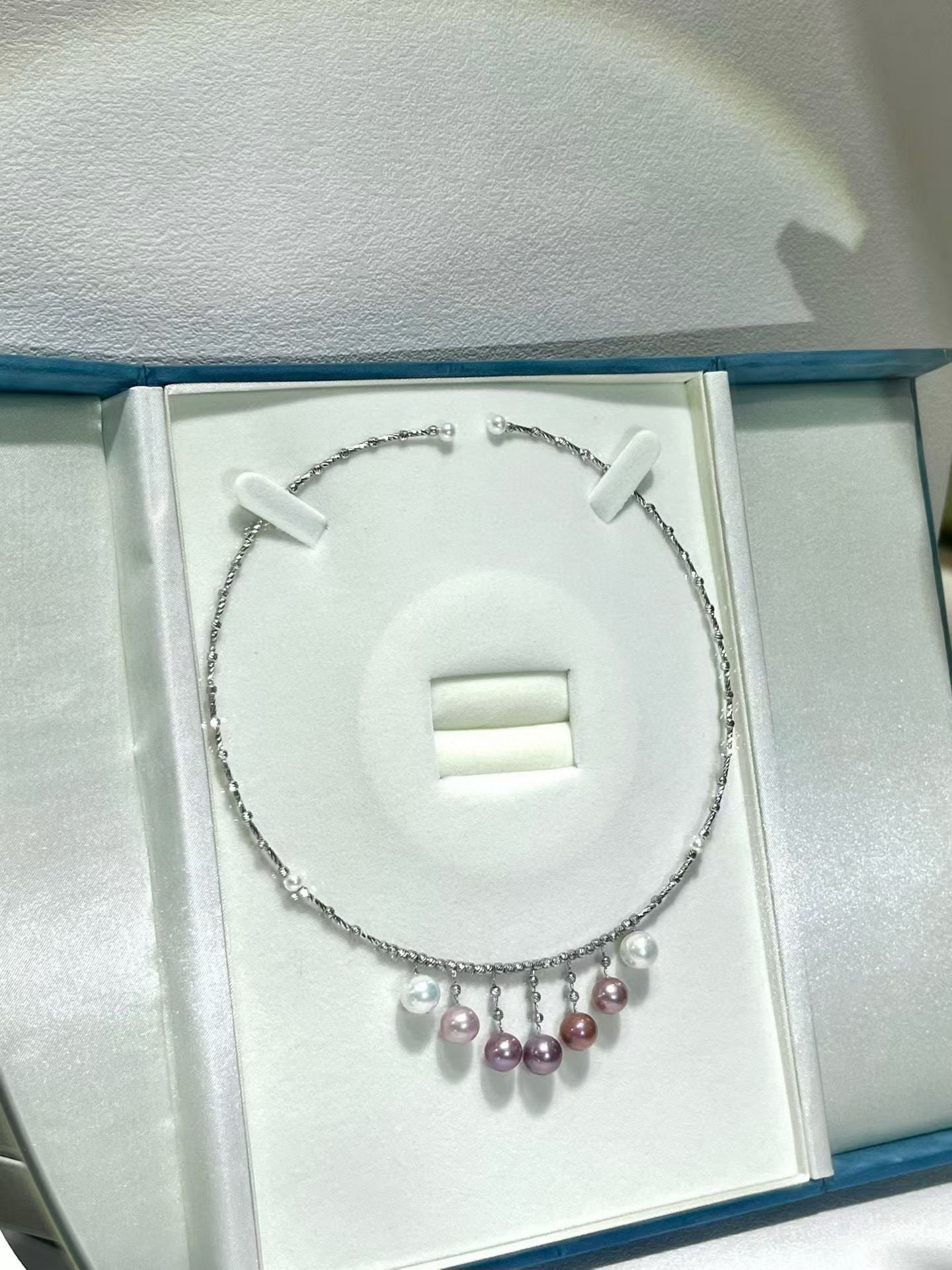 Silver Aurora Freshwater Pearl Necklace: This necklace is meticulously crafted with silver fittings, showcasing the natural luster of the pearls. The pearls range from 4 to 9 millimeters, suitable for various occasions. The adjustable