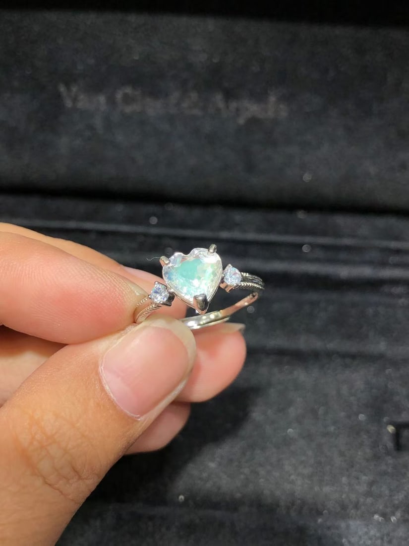 Natural Moonstone Ring: This ring features a natural moonstone as the main stone, showcasing its unique luster. Expertly set in S925 sterling silver, it is simple yet elegant. The main stone is approximately heart-shaped