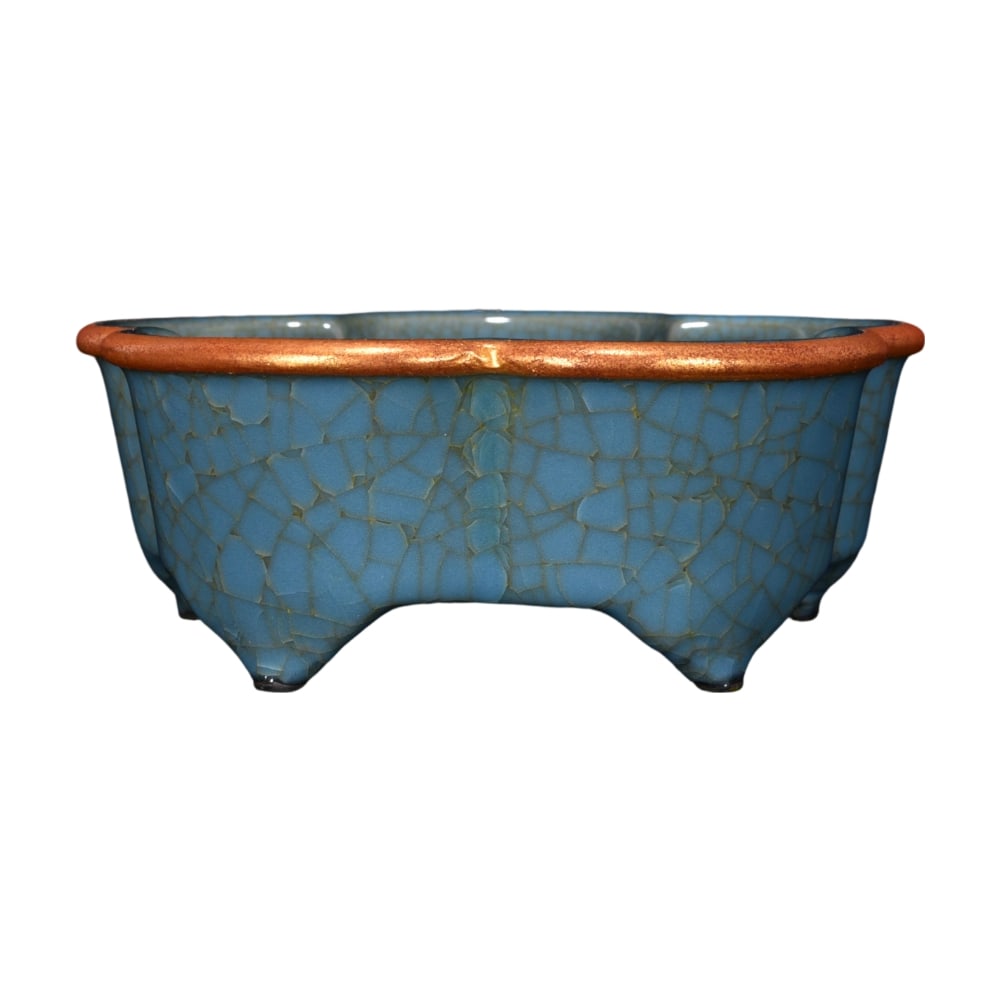 Song Dynasty Guan Kiln Blue Glaze Crackle Plum Blossom Washer: This Song Dynasty Guan Kiln plum blossom washer showcases an ancient and elegant beauty with its unique blue glaze crackle technique. The inscriptions at the rim and the gilded lady motifs complement