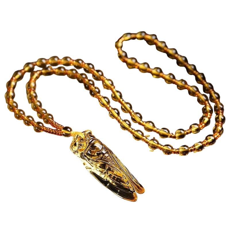 Natural Amber Crystal Cicada Pendant: This pendant is carved from natural amber, depicting the image of a cicada, symbolizing longevity and good fortune. The amber has a warm texture and bright color, making it highly collectible. (5*1.7*