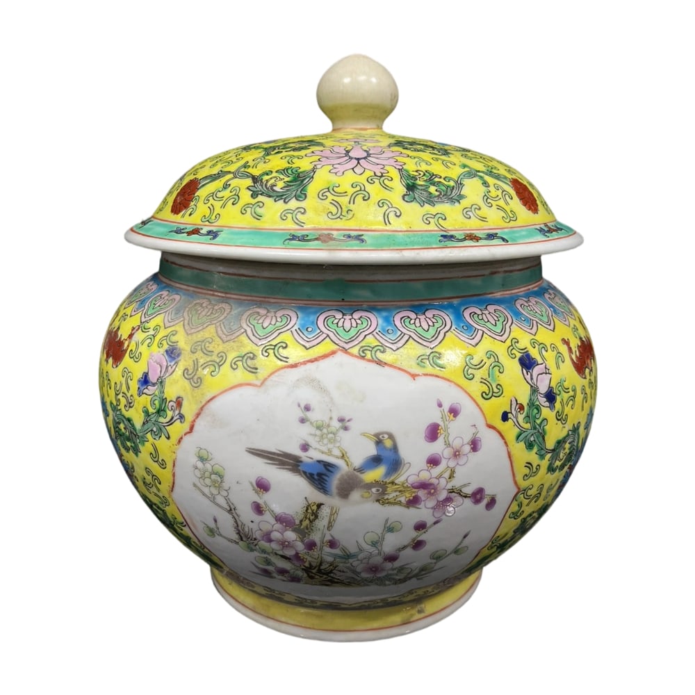 Qianlong Period Enamel Yellow Glaze Floral and Bird Motif Covered Jar: The Qianlong period enamel yellow glaze covered jar, adorned with exquisite floral and bird motifs, represents the pinnacle of royal craftsmanship. The yellow glaze base complements the vibrant
