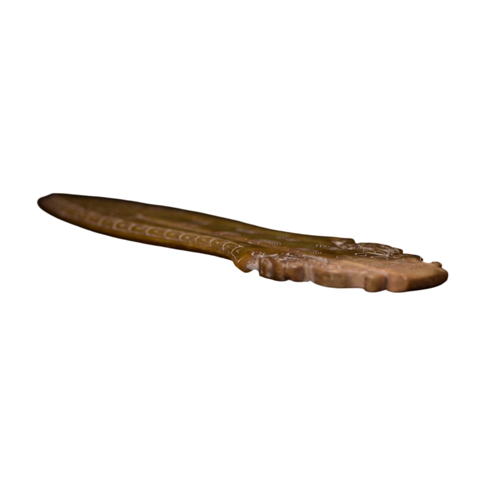 Hetian Jade Weapon: This Hetian jade weapon exhibits a gentle luster throughout, with fine jade quality and even color. The exquisite carving showcases the superb craftsmanship of ancient artisans, and the flowing