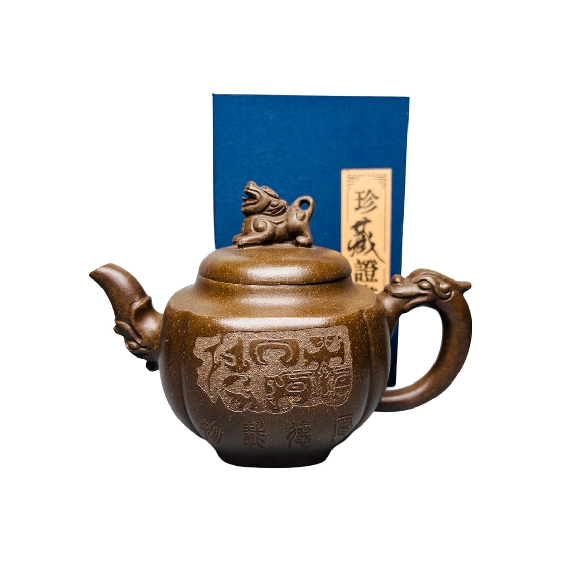 Zisha Original Ore Ancient Bronze Sand Teapot: This teapot, crafted by renowned Zisha master Gu Jingzhou, uses original ore ancient bronze sand, featuring a fine texture and an antique hue. The teapot's dignified shape and profound meaning embody 