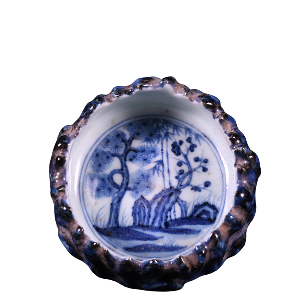 Ming Yongle Blue and White Mountain-shaped Brush Washer with Pine, Bamboo, and Plum Design: This blue and white brush washer from the Yongle period of the Ming dynasty features the 'Three Friends of Winter' motif of pine, bamboo, and plum, symbolizing purity and steadfastness. The mountain-s
