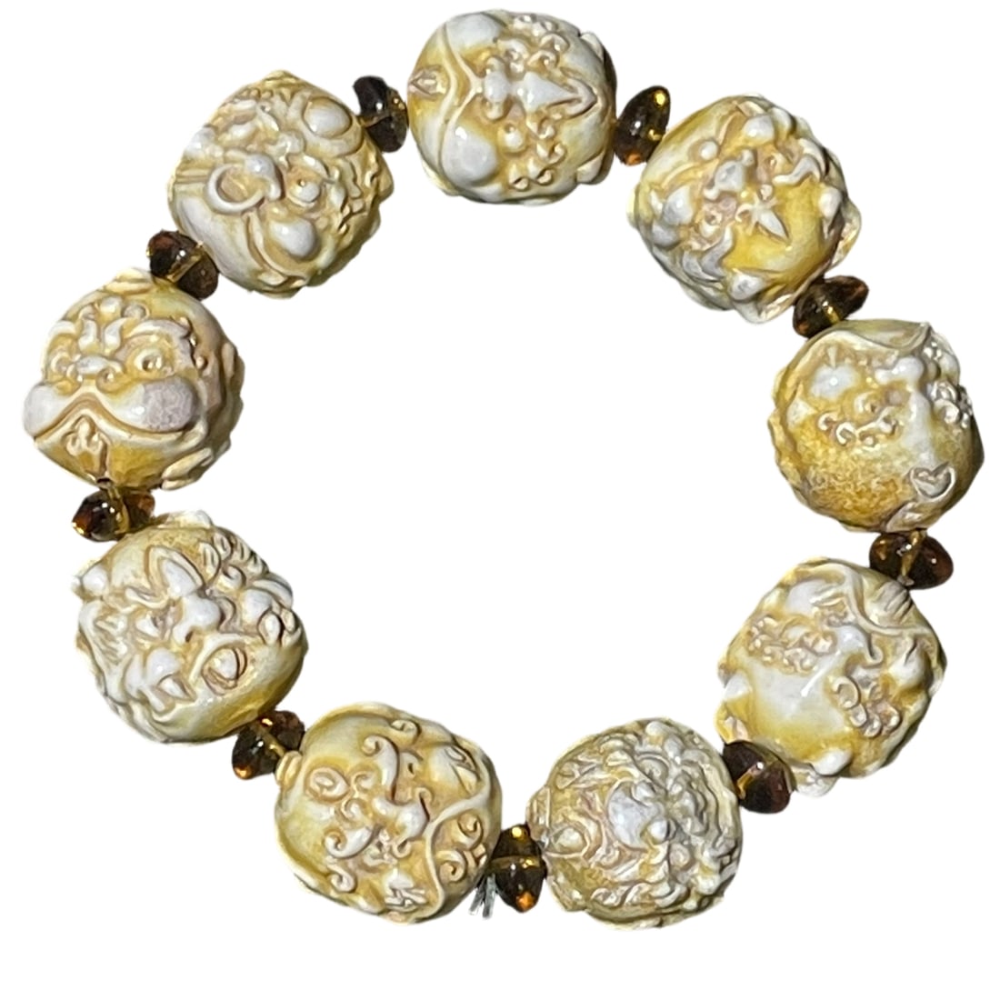 Antler Bracelet with Nine Sons of the Dragon: This bracelet is crafted from precious antler, featuring clear textures and exquisite carving of the Nine Sons of the Dragon. The design is vivid with a majestic expression, smooth lines, and an aged