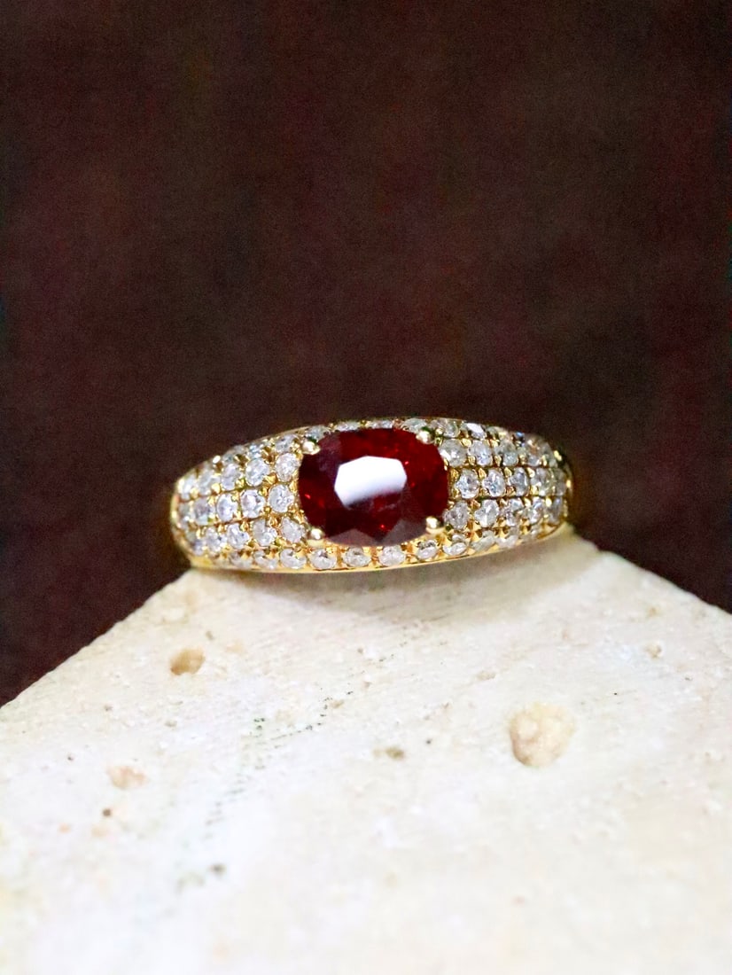 18K Gold Natural Unheated Pigeon's Blood Ruby Ring: This ring is meticulously set with an unheated pigeon's blood ruby in 18K gold, featuring a staggered design that enhances its three-dimensional appeal. Its unique shape elongates the finger line,