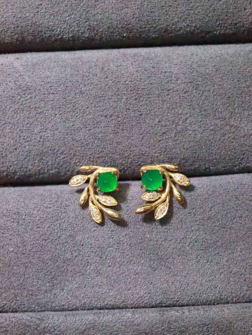 18K Gold Natural Emerald Earrings: These earrings are crafted in 18K gold, featuring a bright and clean emerald crystal, embodying a simple yet elegant style. The fashionable and exquisite design is suitable for various occasions.
