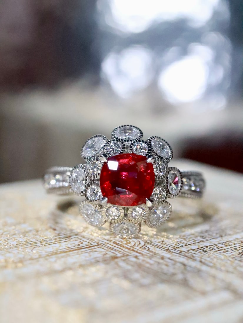 PT950 Natural Unheated Ruby Ring: This ring features a natural unheated ruby as the main stone, with a sweet and transparent crystal. Diamonds are elegantly set around it, enhancing the ruby's eternal charm. Crafted in PT950