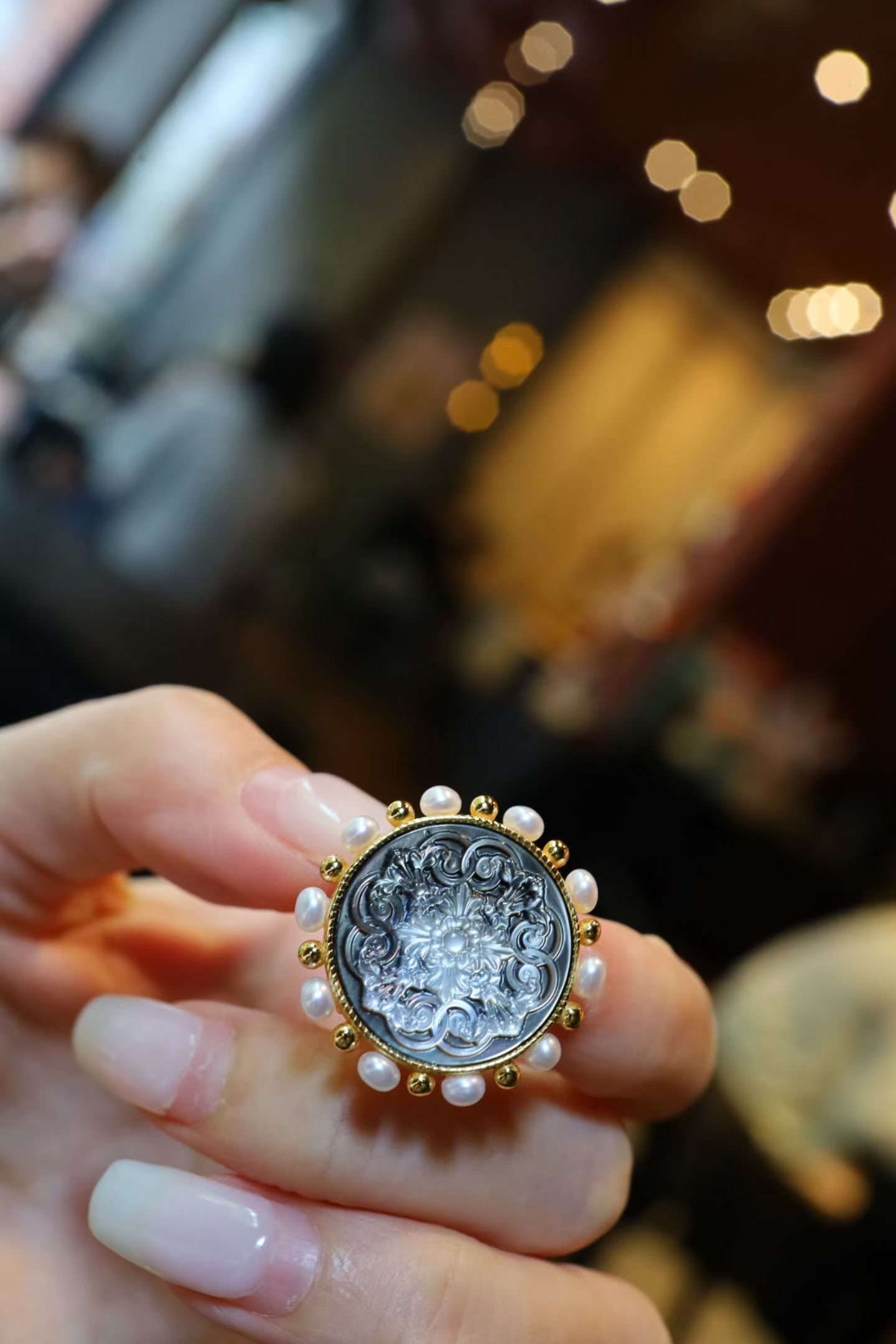 Natural Pearl Black Mother-of-Pearl Brooch: This brooch features a natural black mother-of-pearl as its main body, with exquisite hand-carved patterns. The natural pearl embellishments add an elegant touch to the piece. Made entirely of silver,