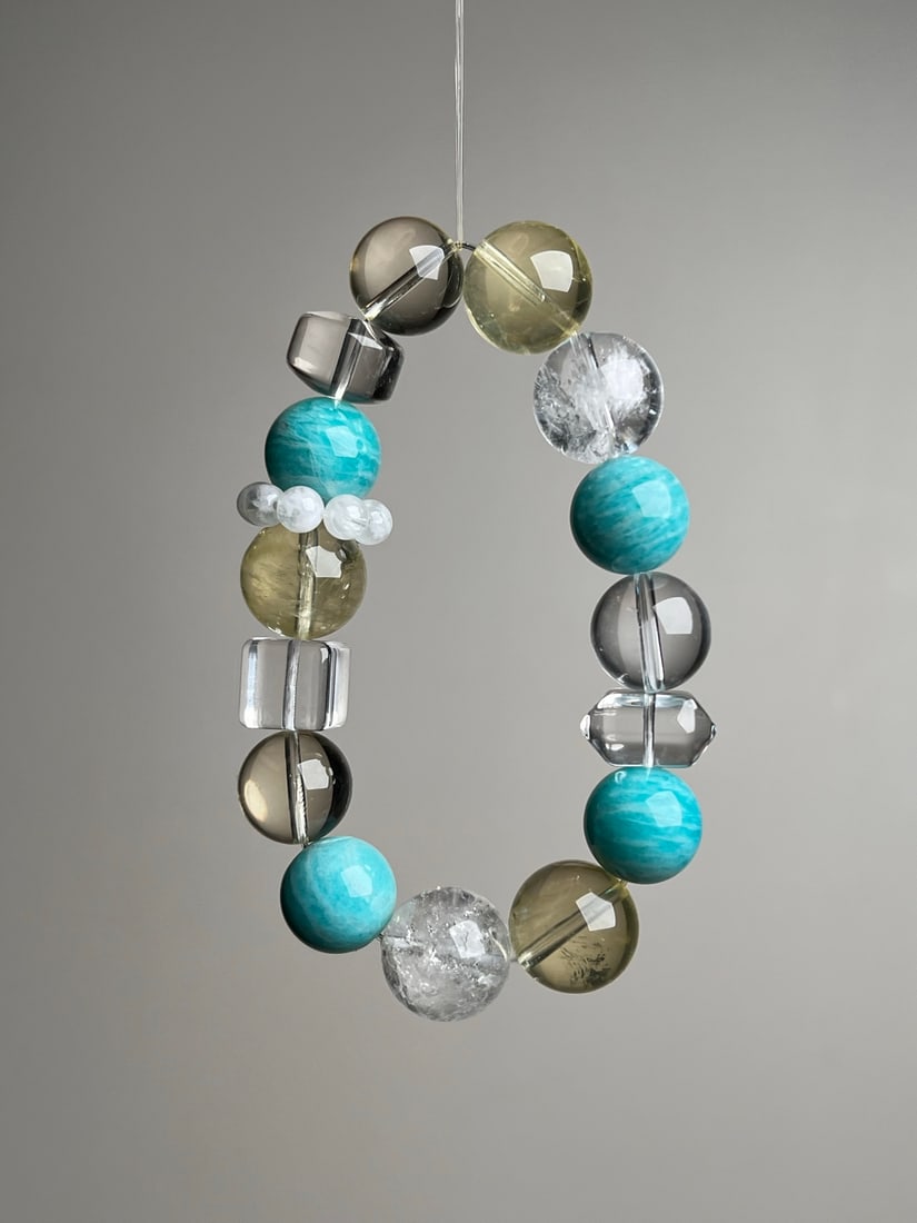 Natural Crystal Bracelet: This natural crystal bracelet is composed of various precious crystals, showcasing the purity and harmony of nature. Each bead is carefully selected to form a unique combination, perfect for those who