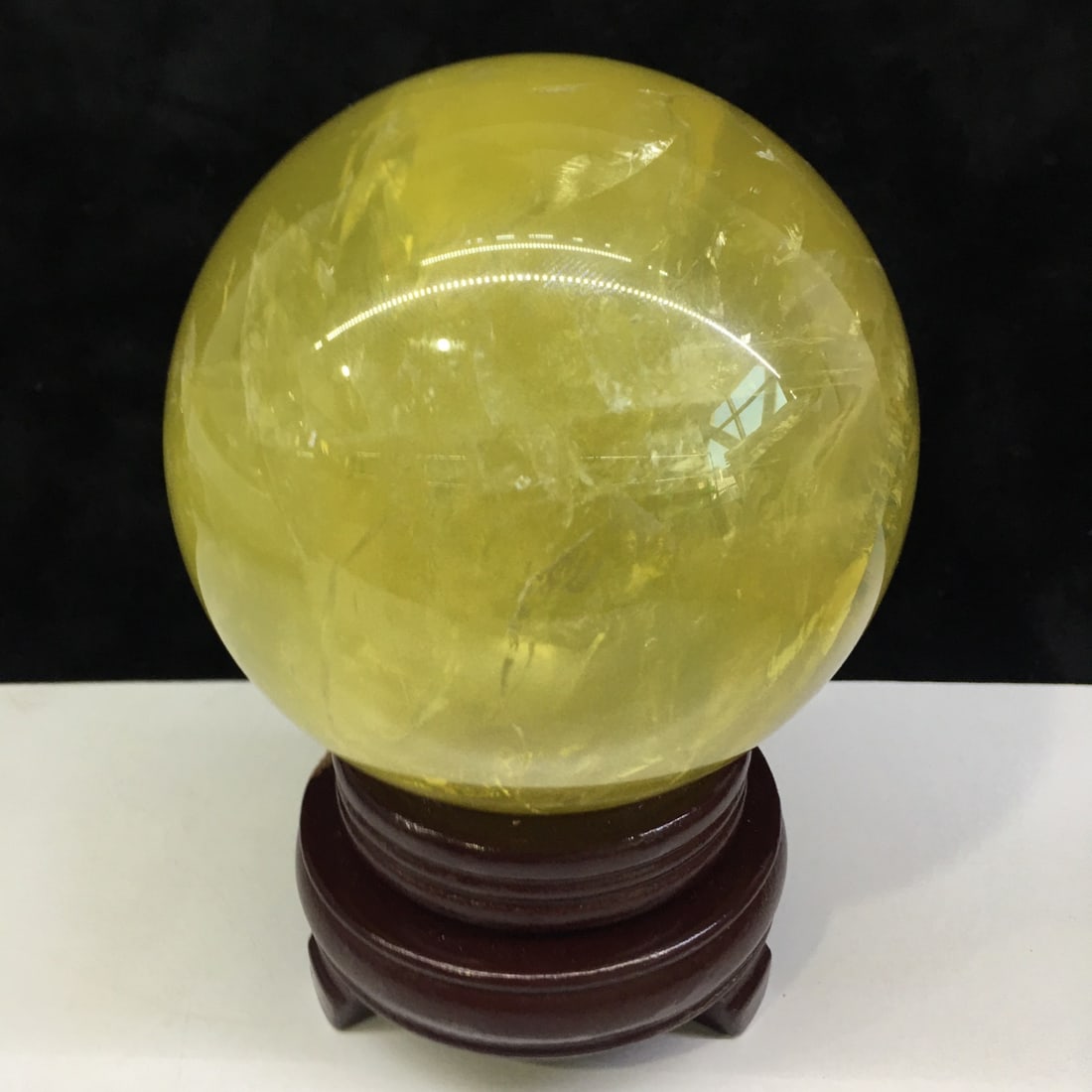 Natural Citrine Sphere: This natural citrine sphere, with its warm hue and luster, stands out as a highlight in any space. Its smooth shape symbolizes completeness and harmony, making it ideal for home or office placement. C