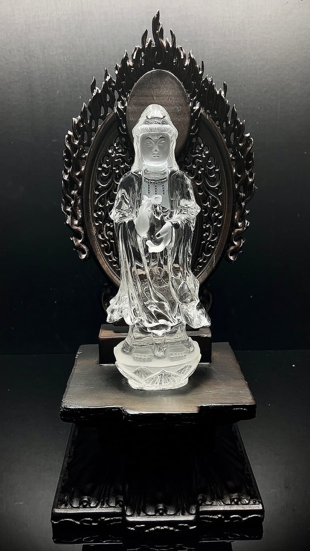 Natural White Crystal Guanyin Ornament: Guanyin stands on a lotus platform, holding a treasure vase, with a serene and dignified expression. The crystal is clean and transparent, with exquisite carving and vivid form. Paired with a finely c