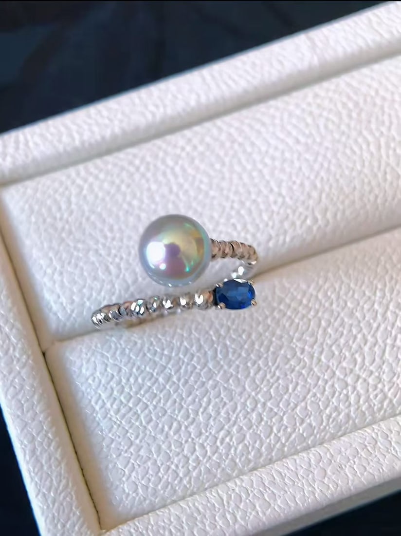 Natural Pearl Ring: This ring features a natural pearl as the main stone, with a diameter of 8-8.5mm, showcasing an elegant silver-gray tone. The pearl is perfectly round and nearly flawless, complemented by pure silver 