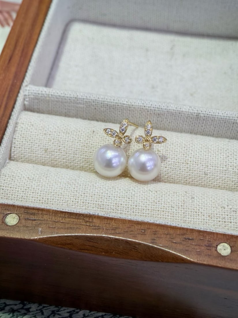 18K Gold Cubic Zirconia Freshwater Pearl Earrings: These earrings are crafted from 18K gold and set with exquisite cubic zirconia, embodying a simple yet elegant style. The 8-9mm freshwater pearls exhibit a strong luster and are nearly flawless, perfe