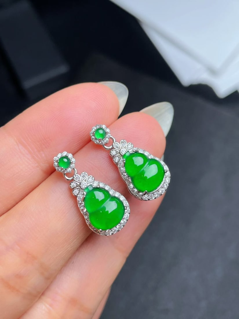 Silver Jadeite Earrings: These earrings are crafted from silver and feature perfect jadeite, showcasing a vibrant green hue. The gourd shape of the jadeite symbolizes good fortune and prosperity, suitable for any occasion. (B