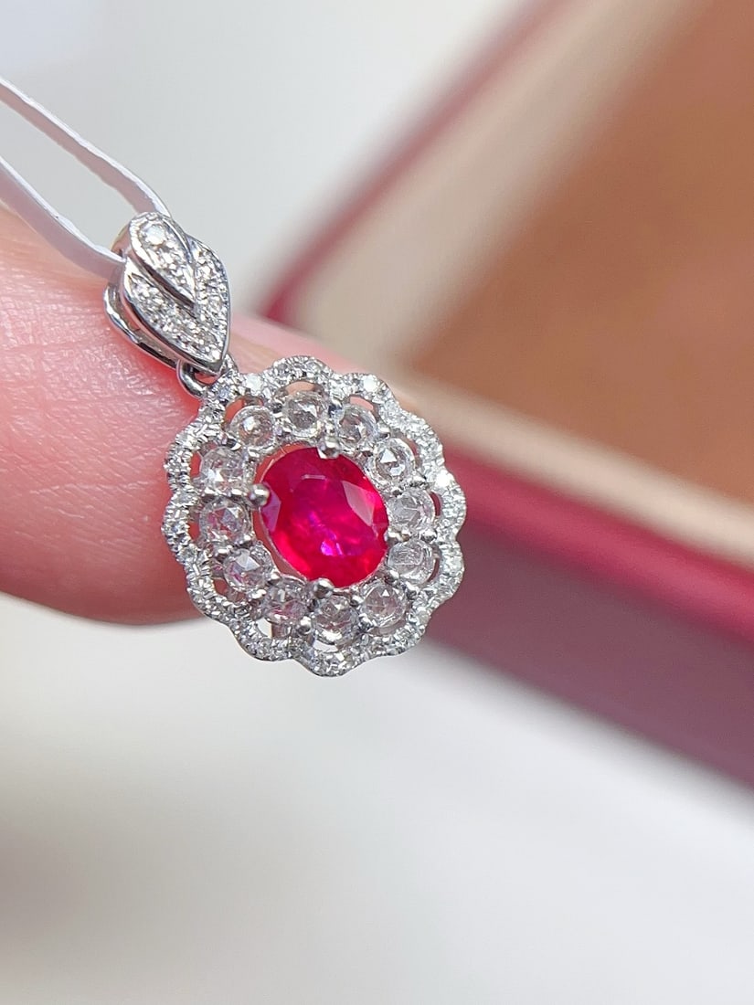 18K Gold Natural Ruby Pendant: This pendant is meticulously crafted in 18K gold, featuring a richly colored natural ruby that exudes an aura of elegance and nobility. The pigeon blood red hue of the ruby complements the surrounding