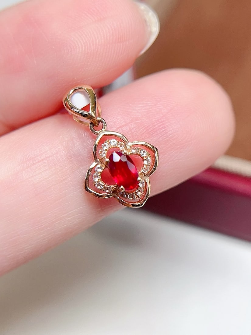 18K Gold Pigeon Blood Red Ruby Pendant: This pendant is meticulously crafted in 18K gold, featuring a vividly colored pigeon blood red ruby, showcasing a classic and elegant design. The ruby's vibrant color and transparency are captivating.