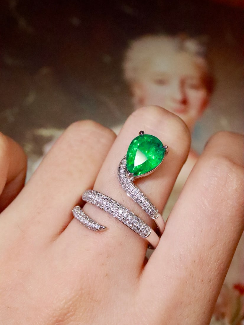Platinum 2.1ct Natural Emerald Diamond Ring: This platinum ring is inspired by a snake design, set with a natural pear-shaped emerald with rich and vivid color, exuding noble elegance. The full diamond design adds a touch of luxury, perfectly